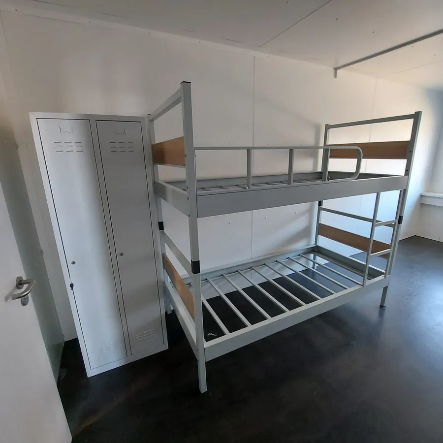 Metal bunk bed and wardrobe in a student dormitory room