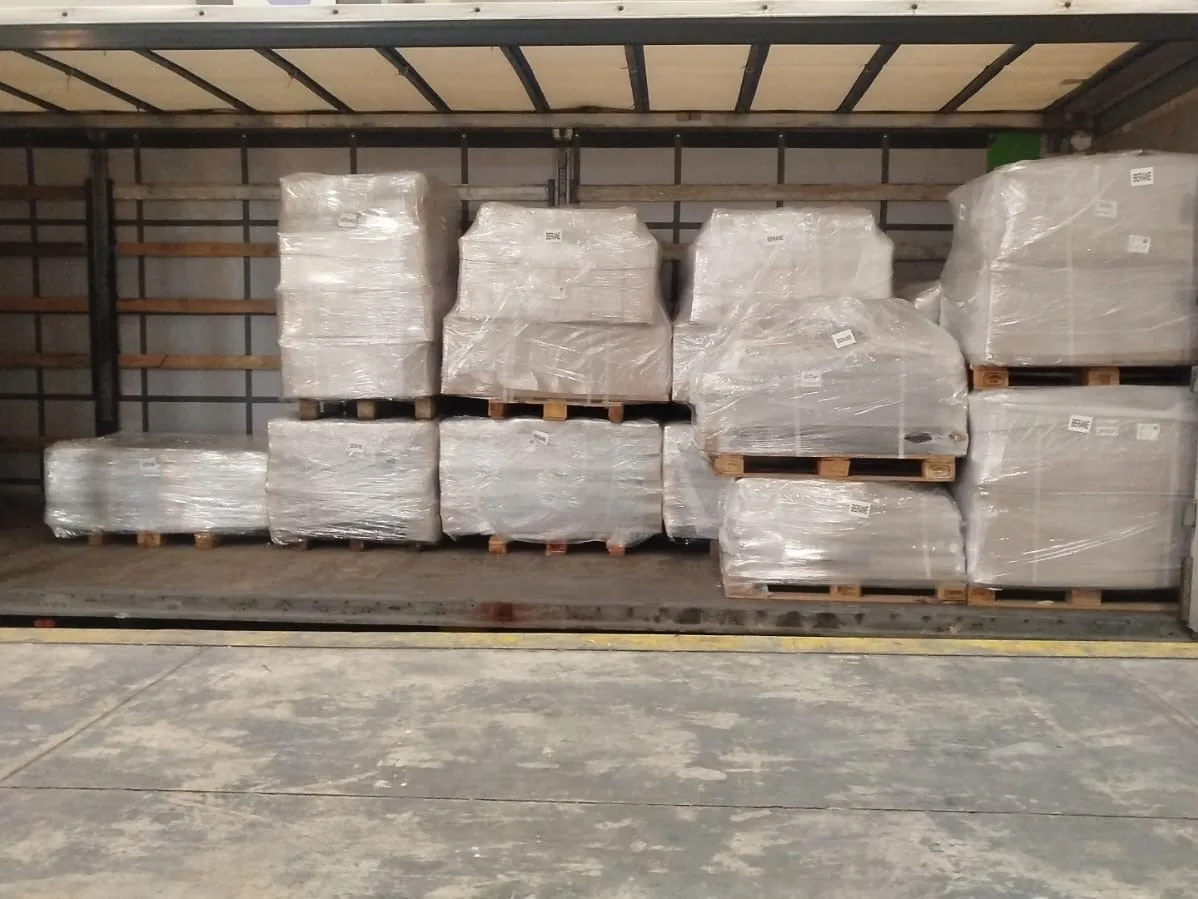 Truck loaded square to the tail with nine stretch-wrapped pallets stacked two high