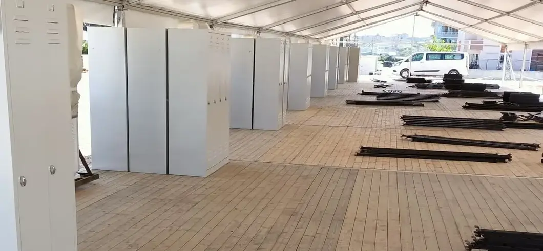 Rows of steel lockers and bunk-bed frames staged for delivery on a large project