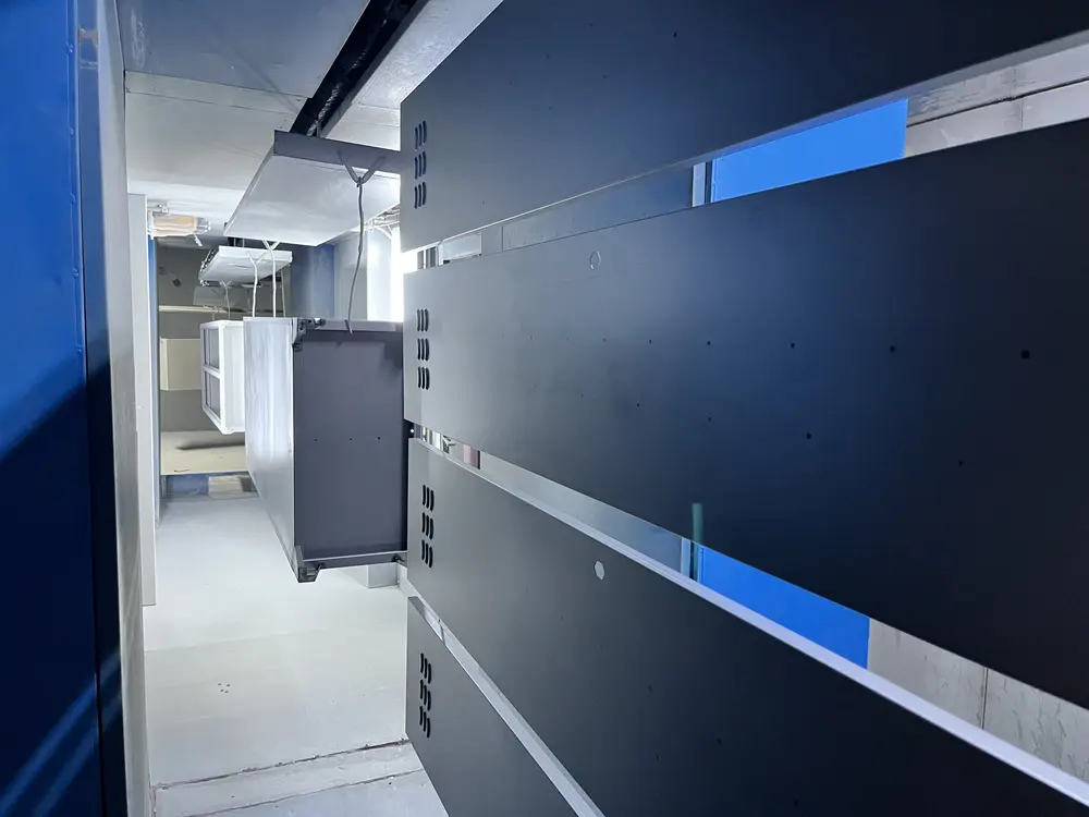 Steel parts on the powder-coating line, before the curing oven