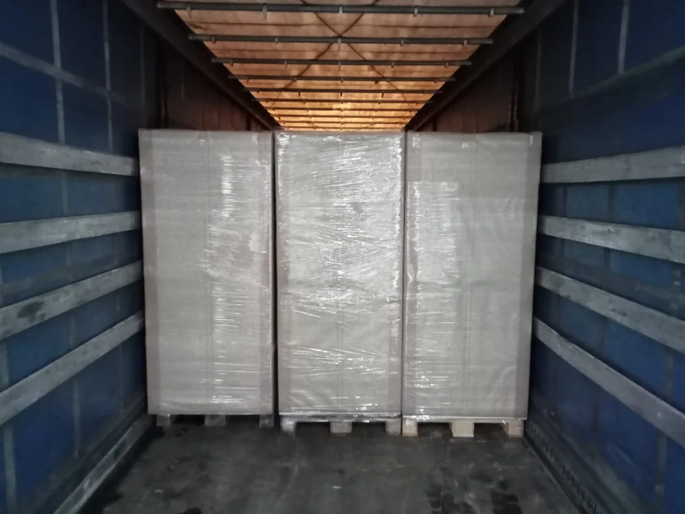 Three wrapped pallets loaded square against the trailer bulkhead