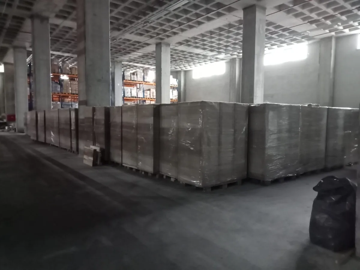 Rows of stretch-wrapped locker pallets in a warehouse before dispatch