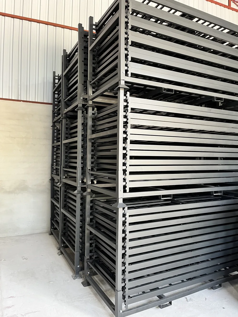 Steel cases loaded with flat bunk bed components, stacked three high in a warehouse