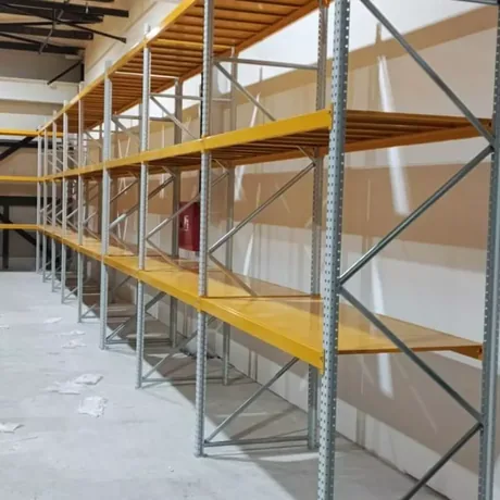 Run of medium duty shelving with galvanized uprights and yellow shelf beams