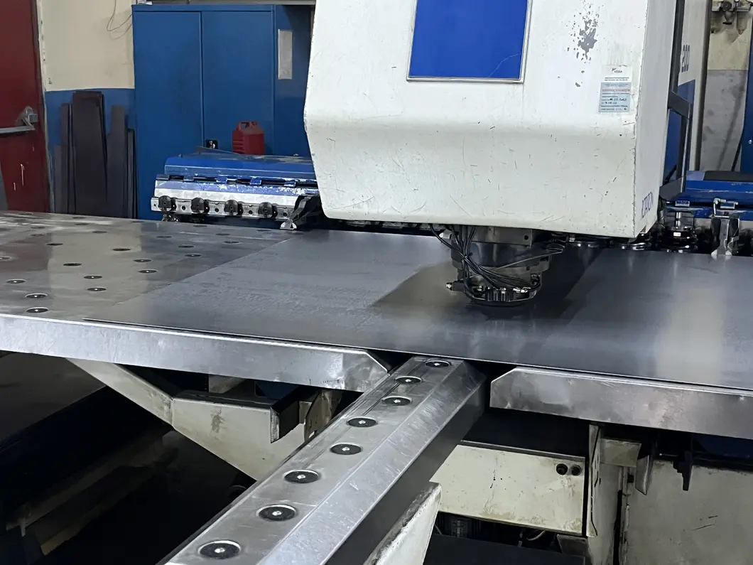 Cold-rolled steel sheet being shaped on a CNC punch press